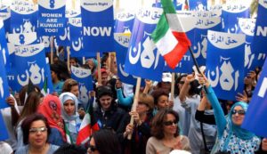 KUWAIT CITY, KUWAIT:  Kuwaiti women demonstrate in front of the parliament building in Kuwait City to demand their political rights, 07 March 2005. As a battle has raged in the Gulf emirate over political rights for its disenfranchised women, female activists and their liberal supporters staged the rally the morning the parliament was scheduled to discuss a government request to speed up the debate on a women's rights bill. The bill, approved by the cabinet last May and opposed by Islamic hardliners, calls for amending article one of the 1962 electoral law which limits voting and candidacy to male citizens whereas the constitution stipulates gender equality.  AFP PHOTO/YASSER AL-ZAYYAT  (Photo credit should read YASSER AL-ZAYYAT/AFP/Getty Images)